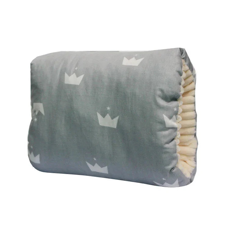Gray pillow with white crown patterns and a soft cream-colored inner lining