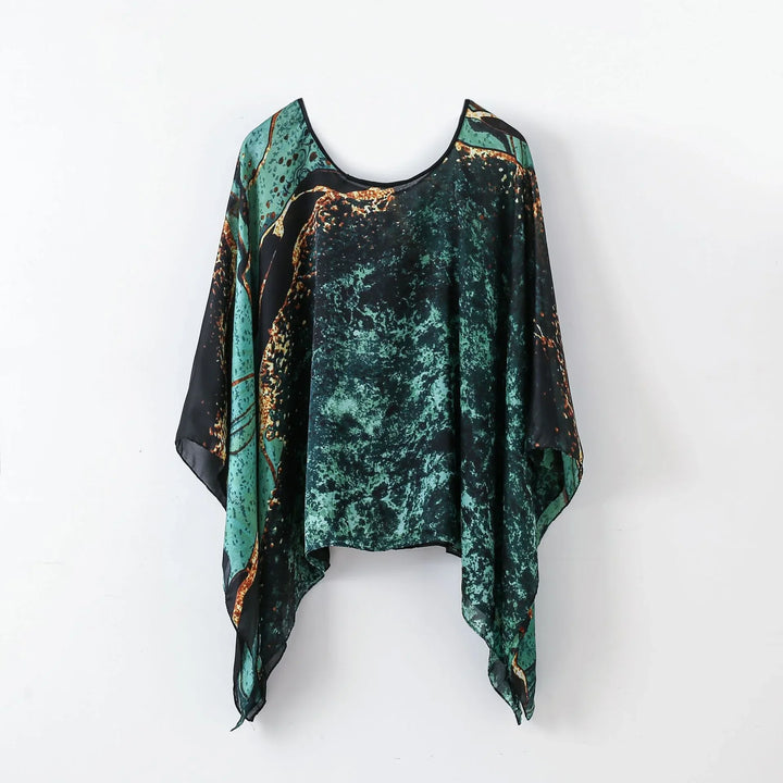 Abstract green and black asymmetrical chiffon blouse with orange accents on white background