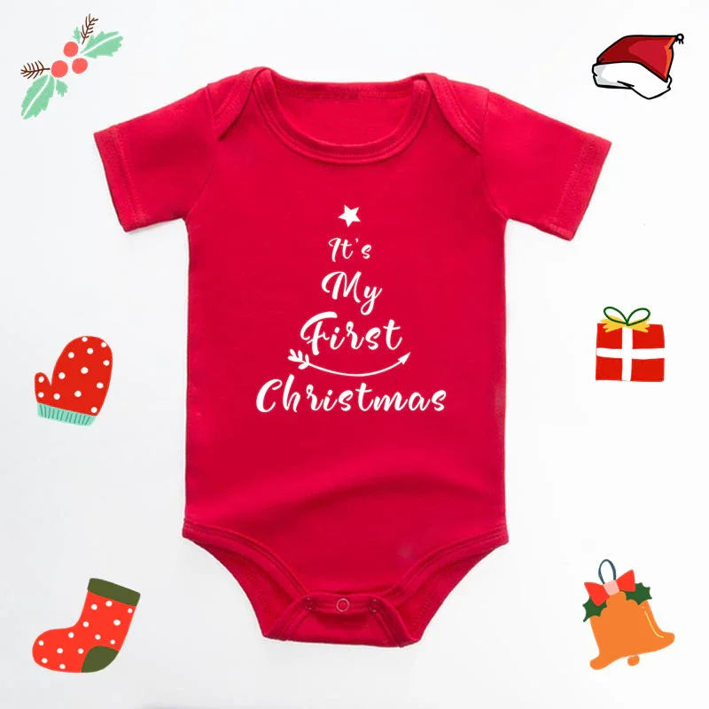 Red baby onesie with white text saying It’s My First Christmas surrounded by Christmas icons