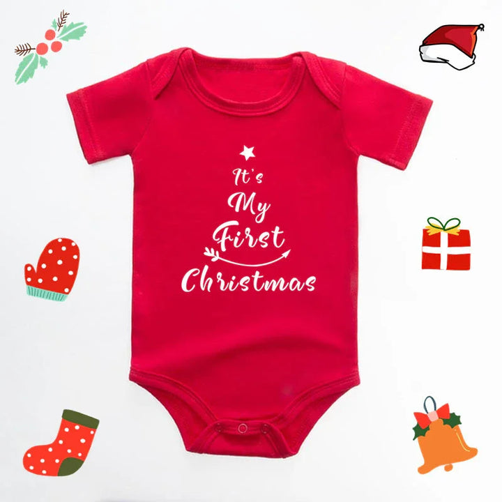 Red baby onesie with white text saying It’s My First Christmas surrounded by Christmas icons