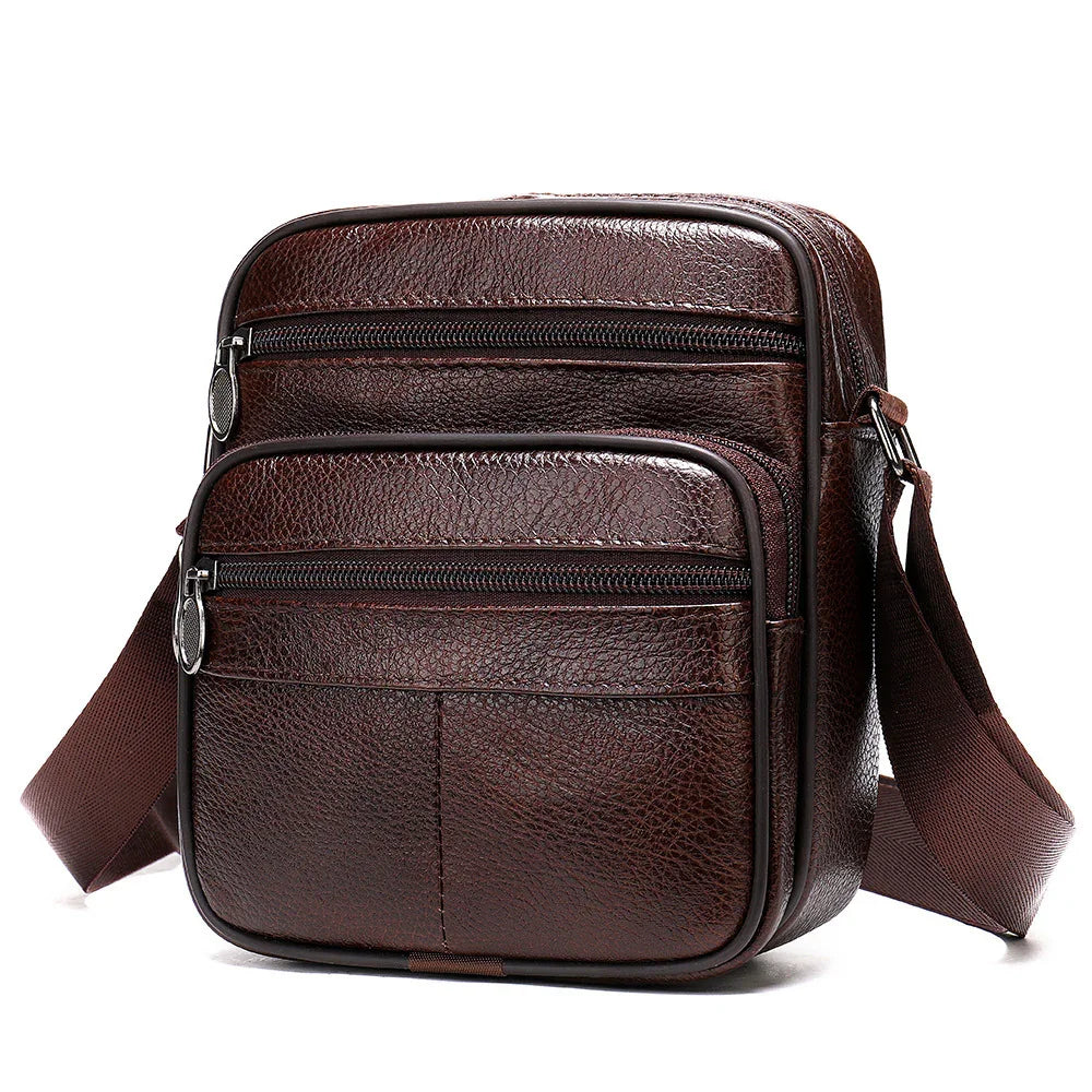 Dark brown leather crossbody sling bag with two zippered compartments and adjustable strap