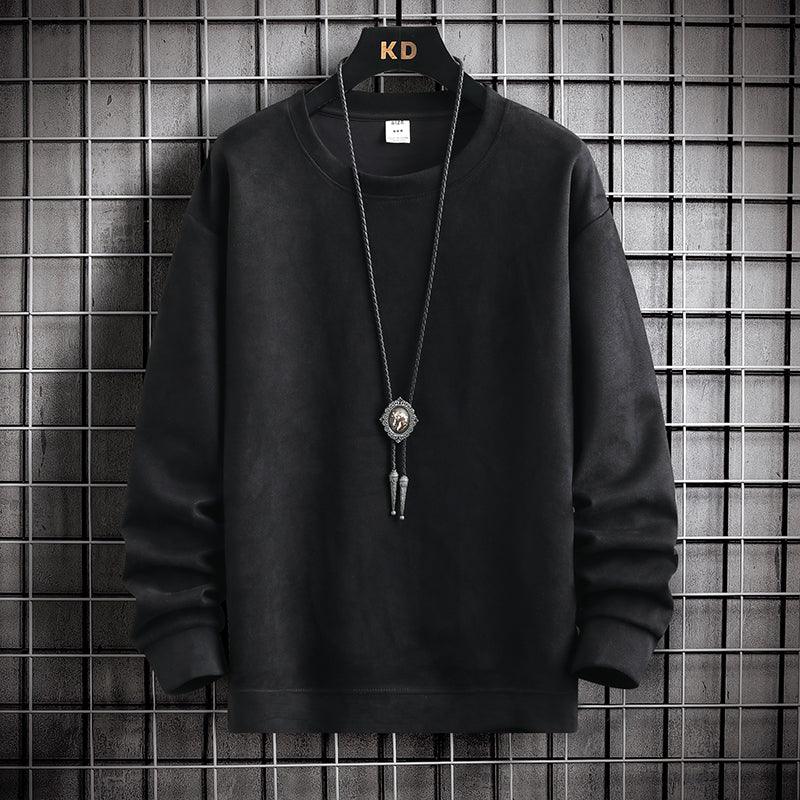 Black long-sleeve sweatshirt on hanger with decorative pendant necklace against grid wall