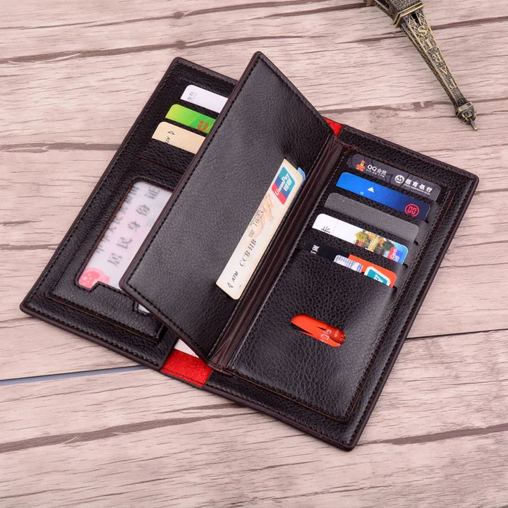 Open black leather wallet with multiple credit cards and ID cards on wooden surface