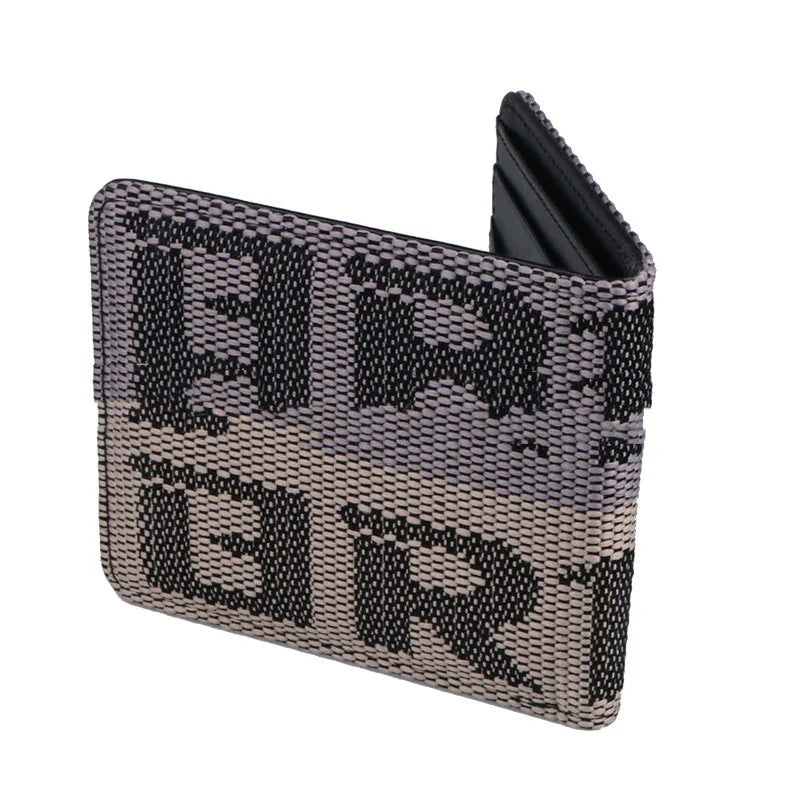 Folded fabric wallet with black and gray textured pattern and bold black letters