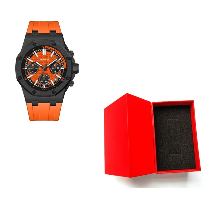 Orange Munit wristwatch with black dial and chronograph features beside an open red watch box with black foam insert