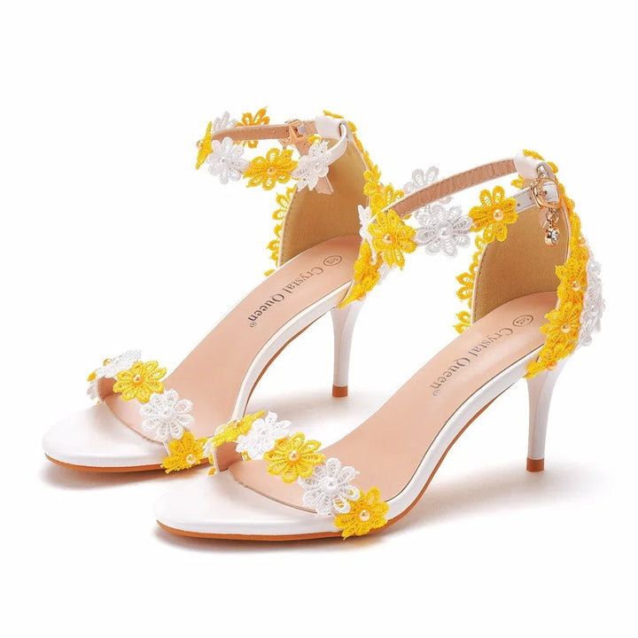 Elegant white high heel sandals with yellow and white floral embroidery and ankle straps
