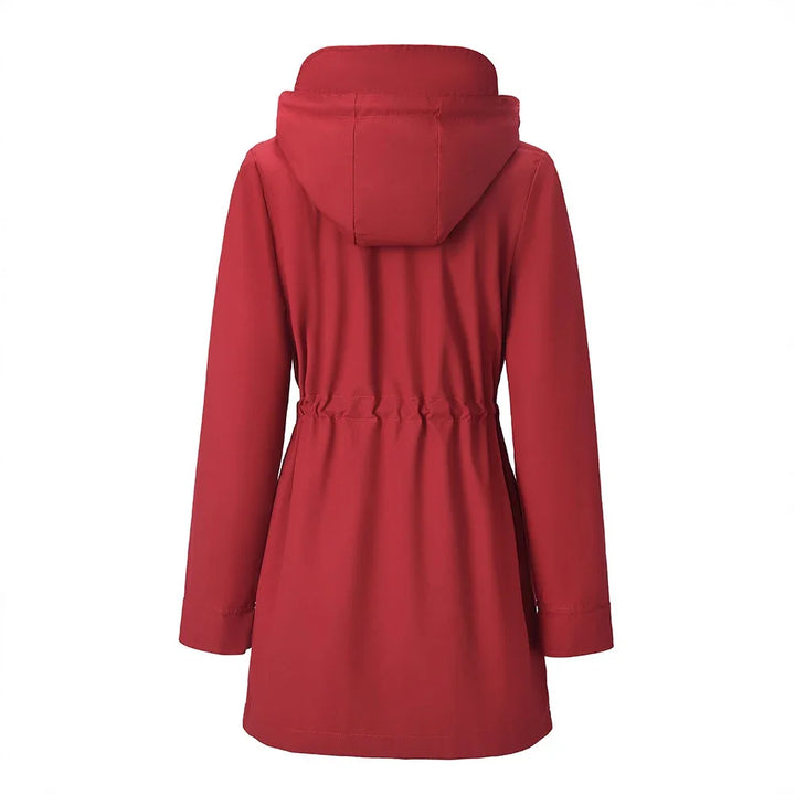 Back view of a red hooded women's rain jacket with elastic waist and long sleeves