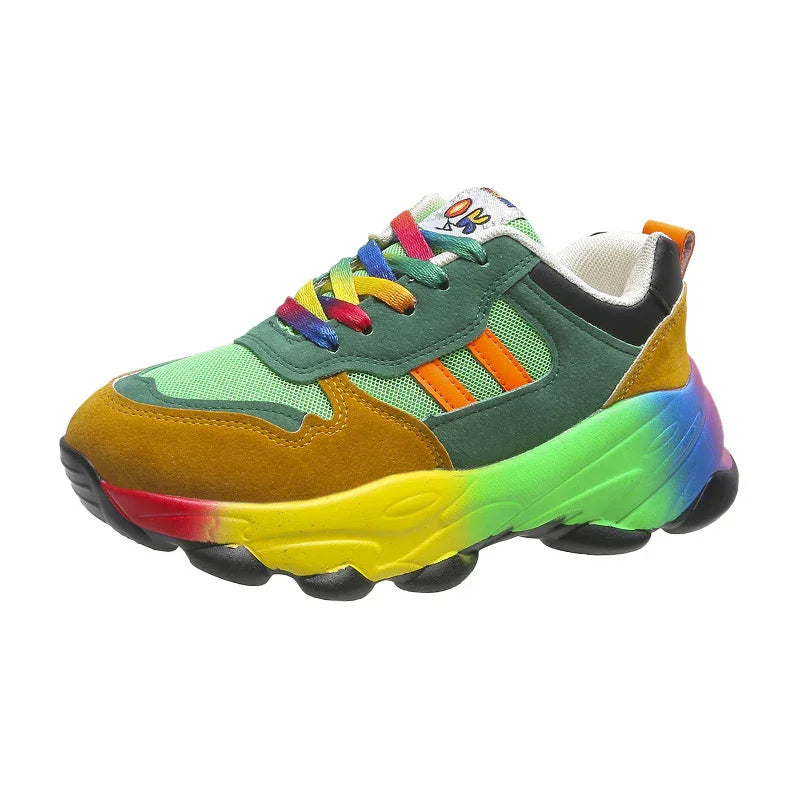 Colorful chunky sneaker with green mesh, mustard suede, rainbow sole, and multicolor laces