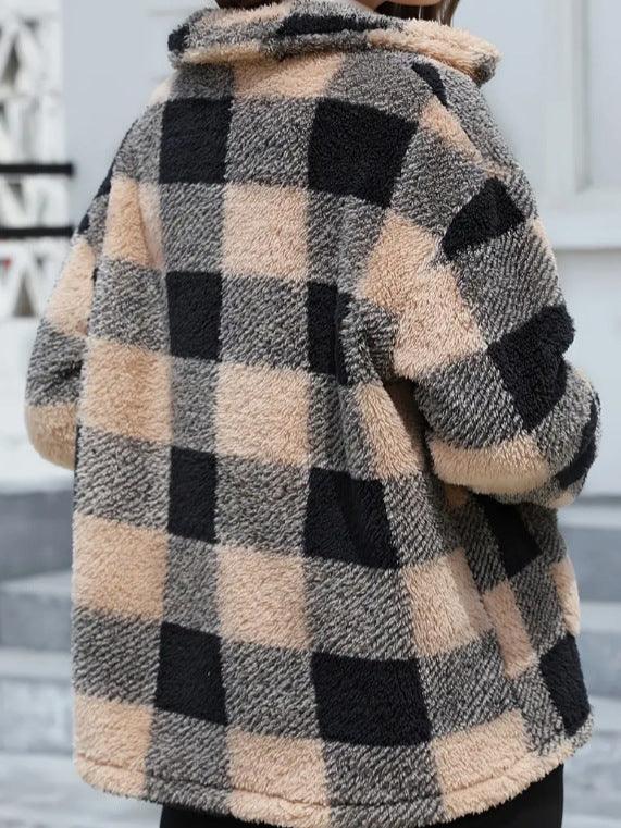 Back view of a person wearing a cozy fleece jacket with black, beige, and gray checkered pattern