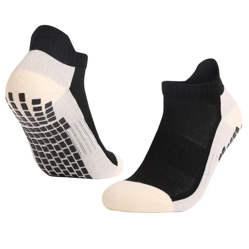 Black and white non-slip ankle socks with padded toes and grid grip soles on white background
