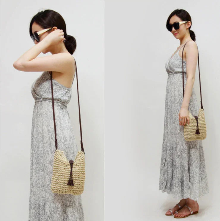 Woman wearing gray floral maxi dress with sunglasses and straw crossbody bag in studio