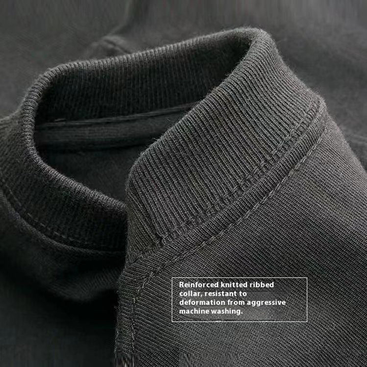 Close-up of black sweatshirt with reinforced knitted ribbed collar, resistant to washing deformation