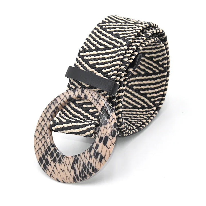 Black and white patterned woven belt with round snake print buckle on white background