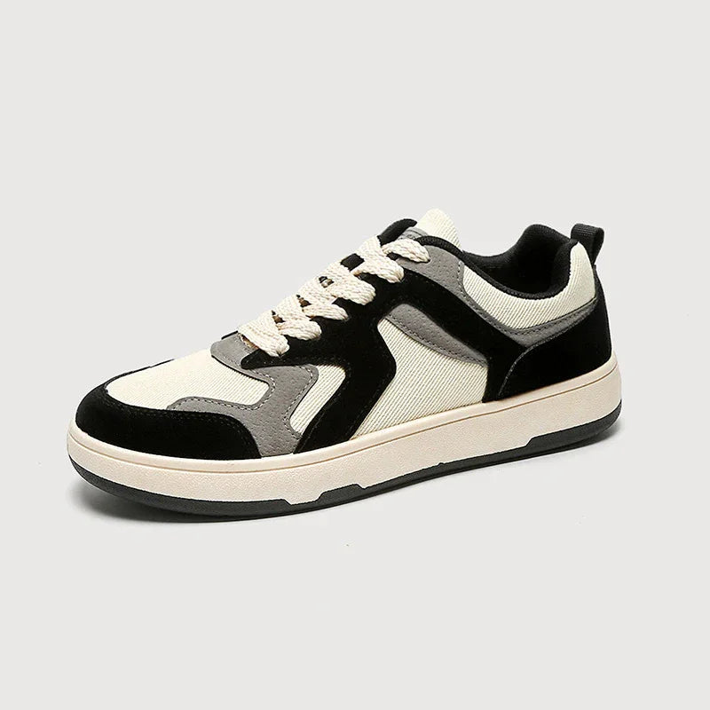 Casual low-top sneaker with black, gray, and cream fabric panels and cream laces on a white background
