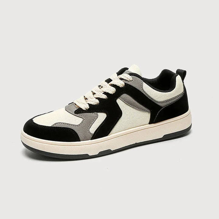 Casual low-top sneaker with black, gray, and cream fabric panels and cream laces on a white background