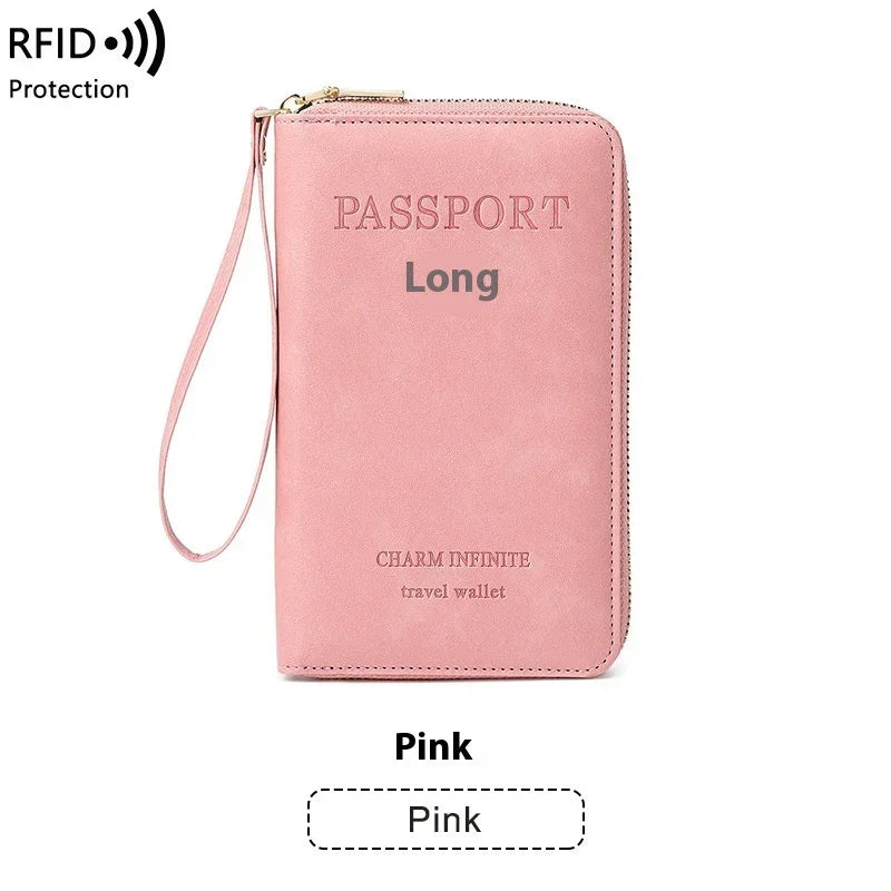 Pink long travel wallet with zipper and wrist strap, RFID protection, labeled 'Passport' and 'Charm Infinite'