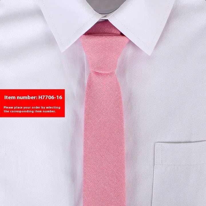 Close-up of light pink textured necktie on white dress shirt with pointed collar and breast pocket
