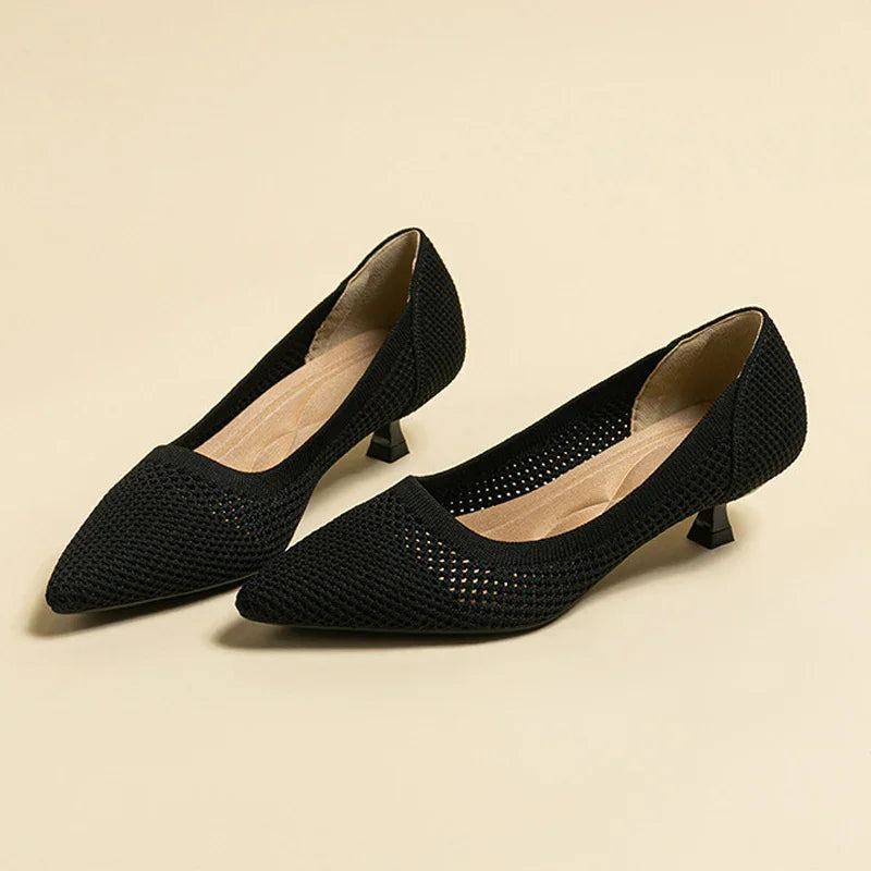 Black knit mesh low heel pointed toe women's shoes on beige background