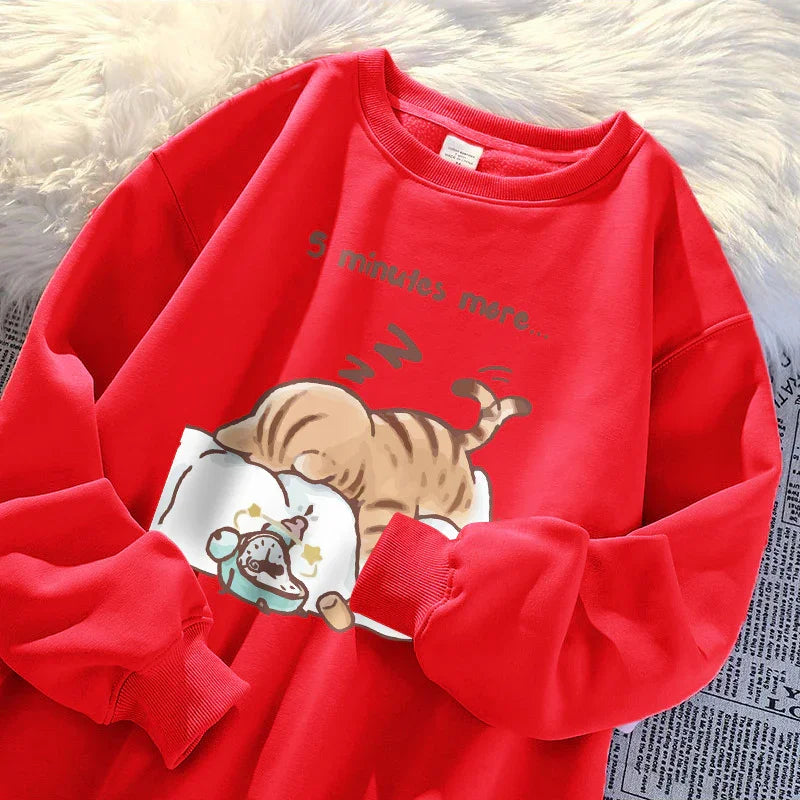 Red sweatshirt with a cartoon cat sleeping on a pillow and text reading '5 minutes more'