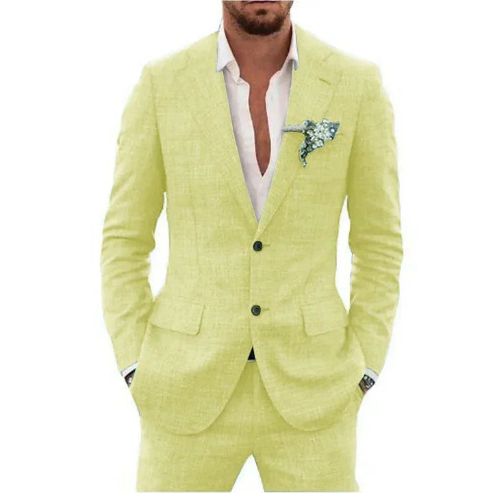 Man wearing light yellow suit with white shirt and floral lapel pin, hands in pockets
