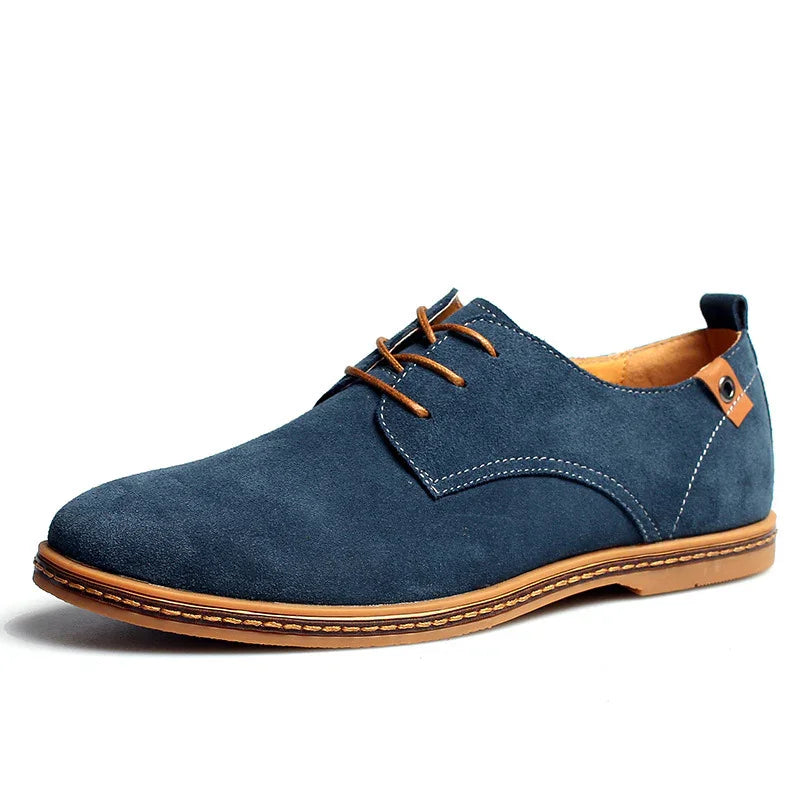 Men's navy blue suede casual dress shoe with brown laces and sole detail