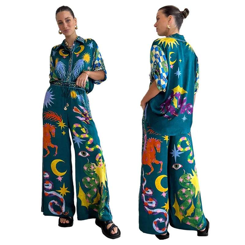 Woman wearing a matching teal wide-leg pants and oversized shirt set with colorful celestial and animal prints