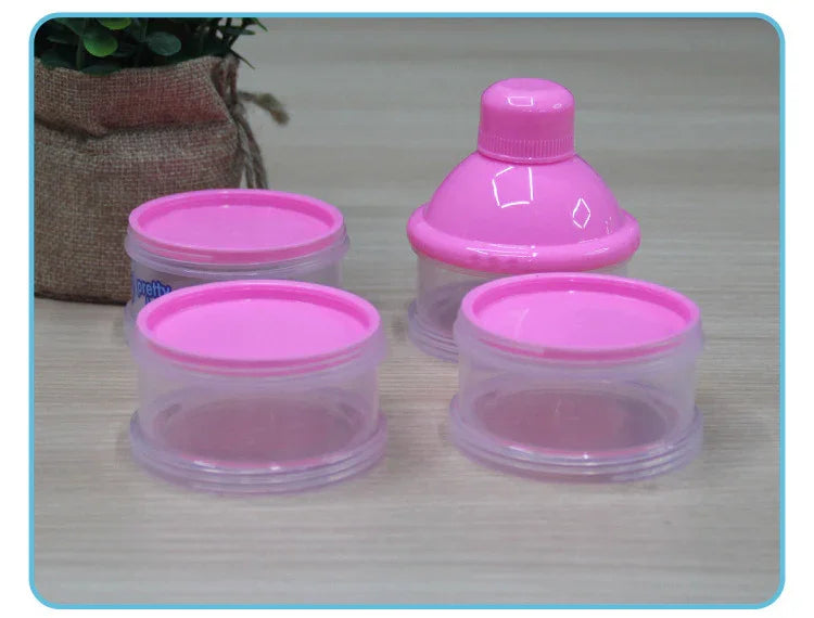 clear plastic containers with pink lids and a pink citrus juicer on a wooden surface