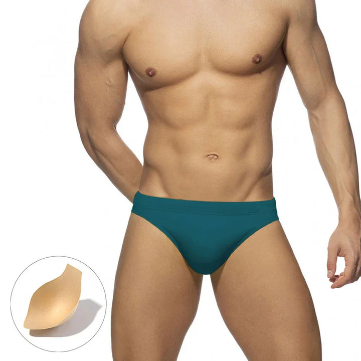 Male torso wearing teal men's swim briefs with padded chest insert detail