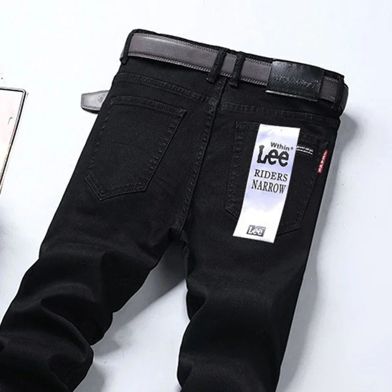 Black Lee Riders Narrow jeans with belt and back tag on white background