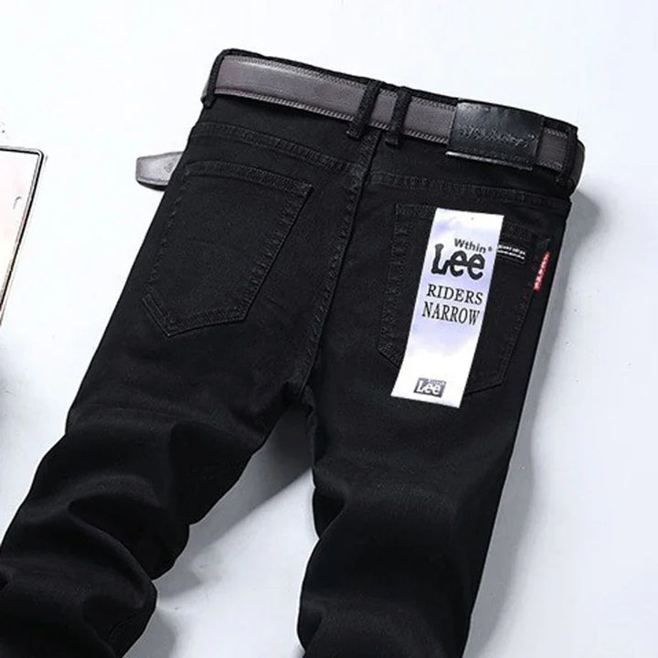 Black Lee Riders Narrow jeans with belt and back tag on white background