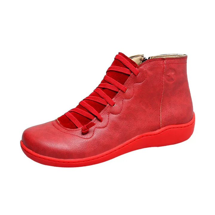 Red leather ankle boot with red laces and matching sole on white background