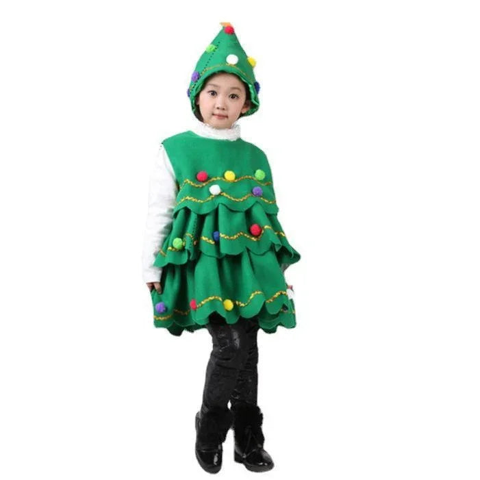 Child wearing green Christmas tree costume with colorful pom-poms, black pants, and boots