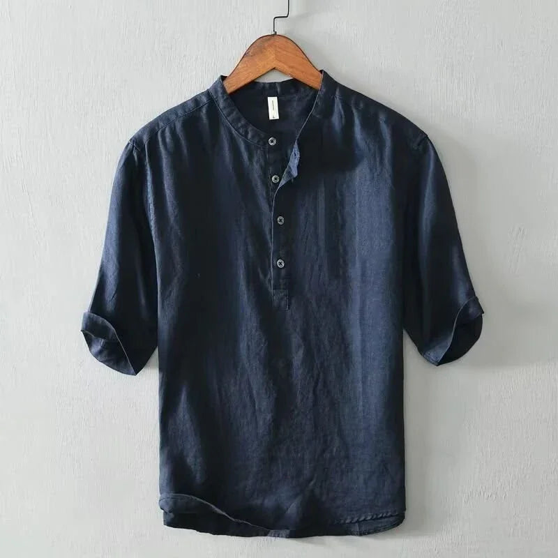 Navy blue men's casual linen shirt with rolled-up sleeves hanging on wooden hanger