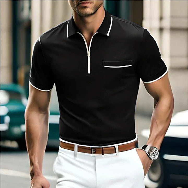 Man wearing black short-sleeve polo shirt with white trim and white pants, brown belt, wristwatch