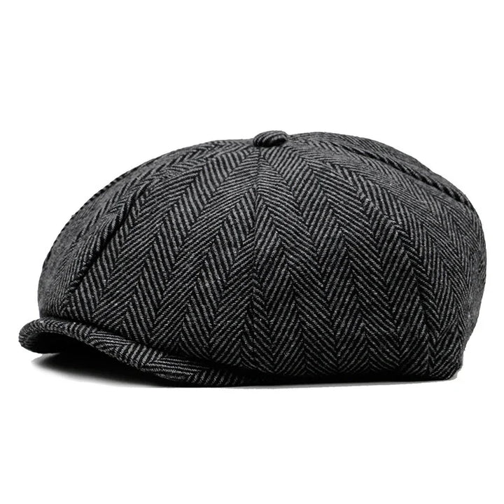 Black and gray herringbone pattern newsboy cap with button on top and small brim