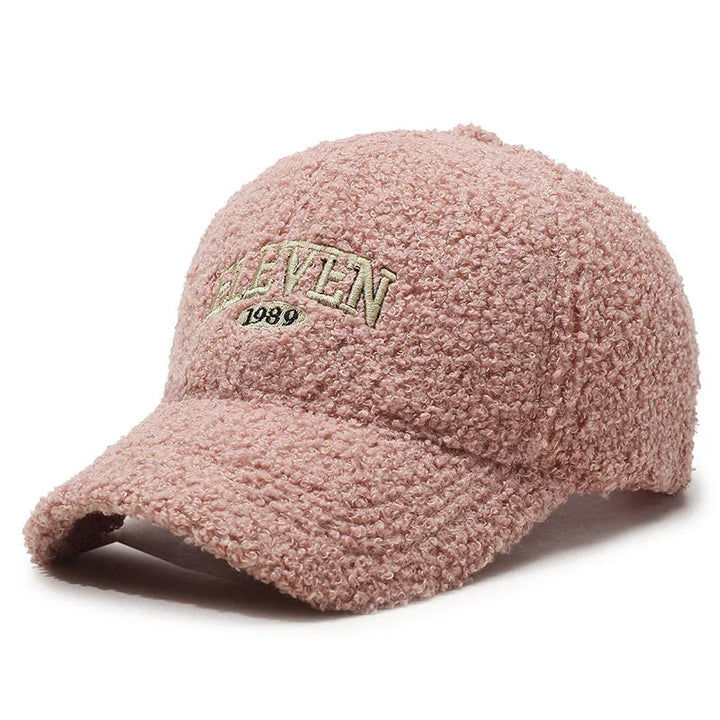 Pink textured baseball cap with beige embroidered text 'HEAVEN 1989' on front