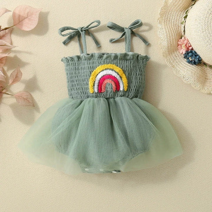Green baby romper dress with embroidered rainbow and tulle skirt, tied shoulder straps