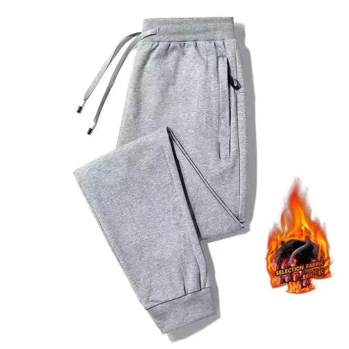 Light grey sweatpants with elastic cuffs and drawstring waistband, displayed on white background