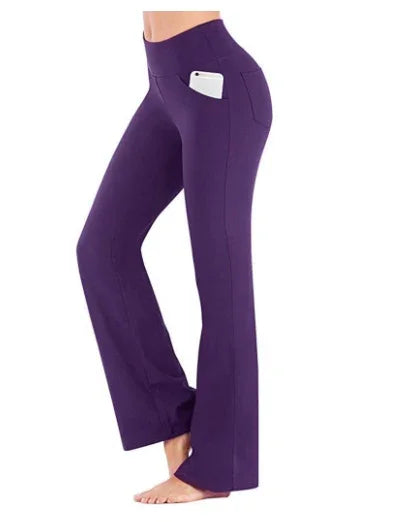 Woman wearing purple yoga pants with side pockets holding a smartphone, barefoot