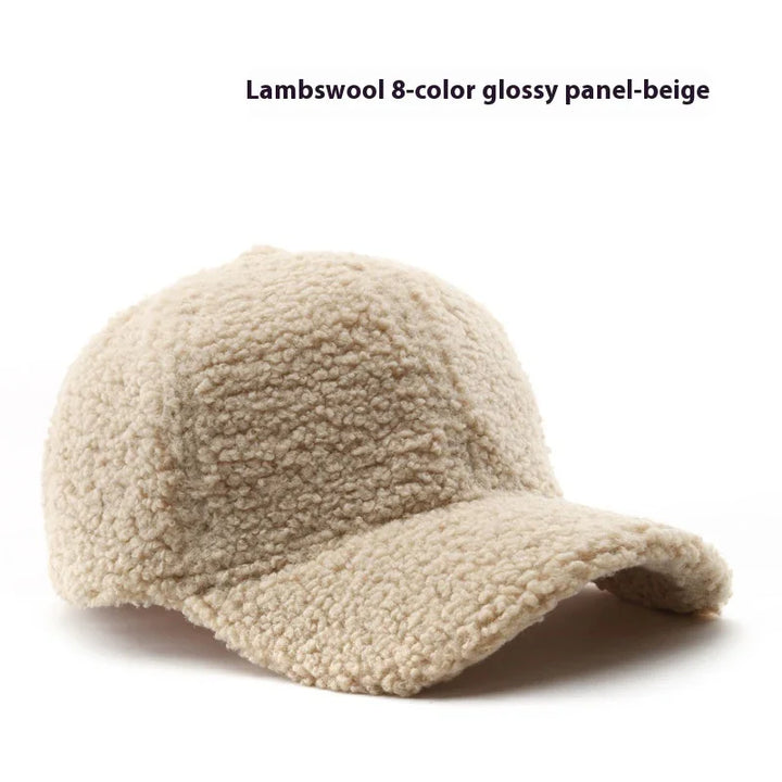 Beige lambswool textured baseball cap with a soft, curly wool finish