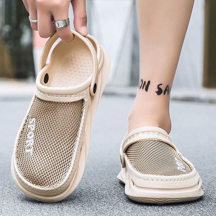 Beige mesh slip-on summer sandals with adjustable strap worn on feet on street