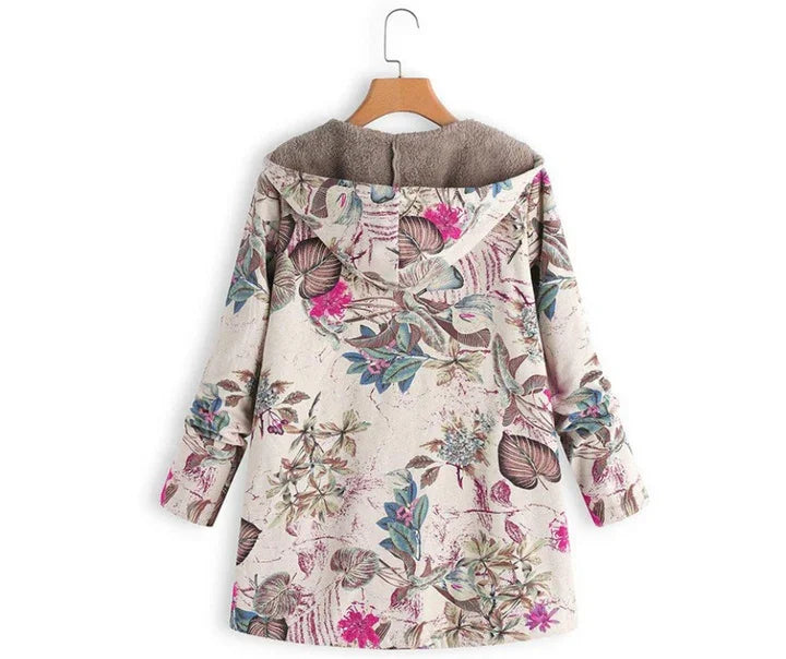 Floral print hooded jacket with fleece lining, beige background, and pink, blue, and brown leaves