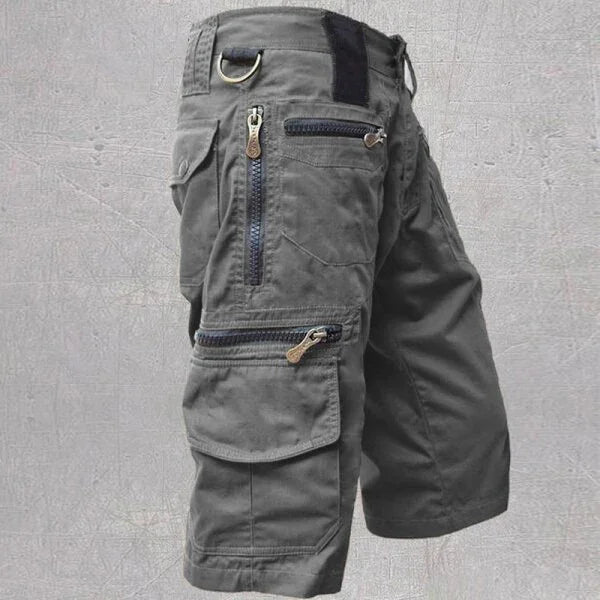 Men's gray cargo shorts with multiple zippered pockets and a D-ring on waistband