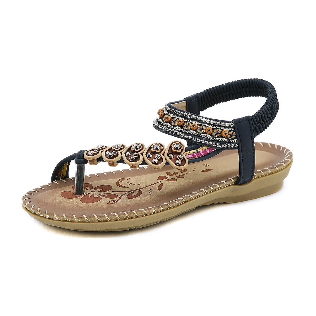 Black and tan beaded women's sandal with floral designs and ankle strap