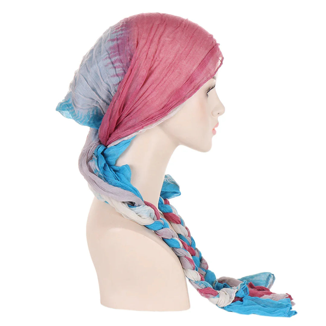 Colorful pink, blue, and gray braided headscarf on mannequin profile against white background