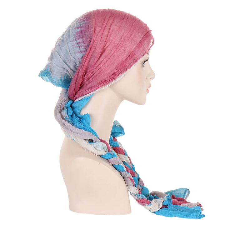 Colorful pink, blue, and gray braided headscarf on mannequin profile against white background
