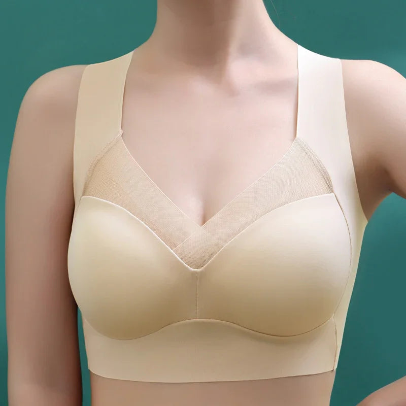 Seamless beige bra with wide straps and mesh v-neck panel, front view on model