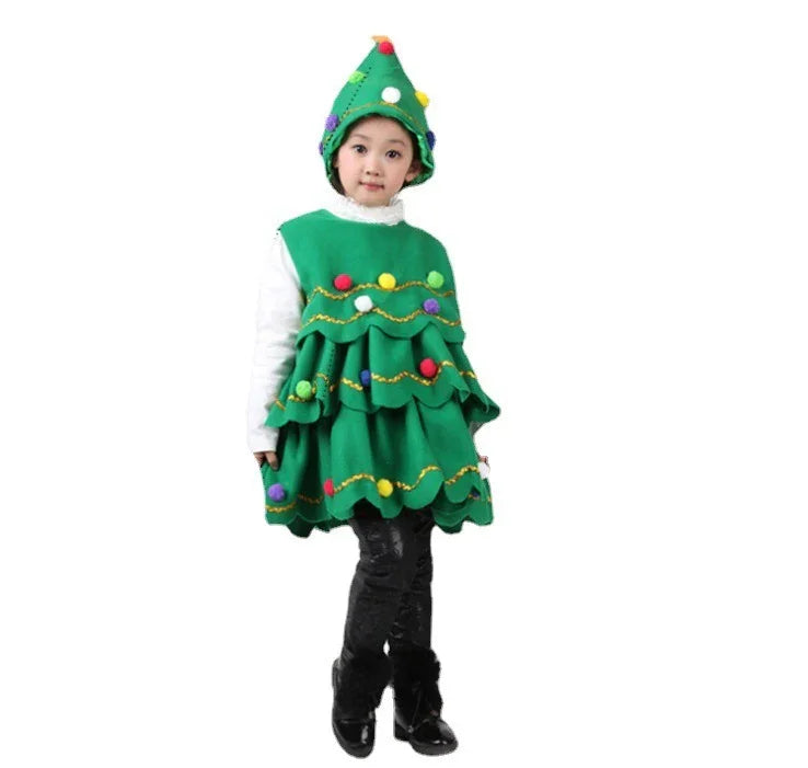 Child wearing a green Christmas tree costume with colorful pom-poms and matching hat