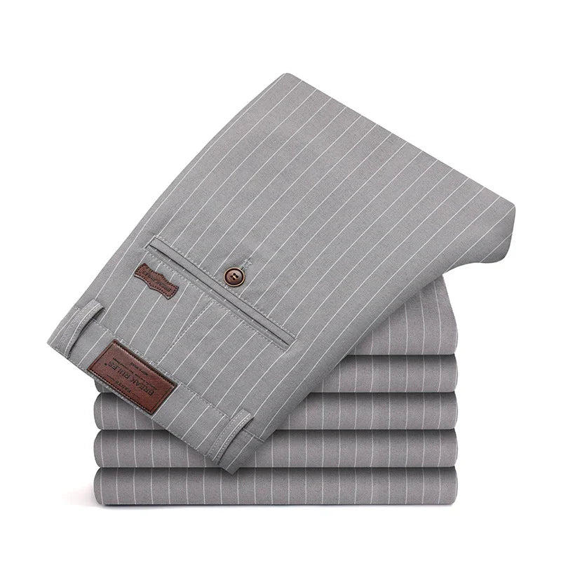 Stack of gray pinstripe dress pants with button pocket and leather brand label