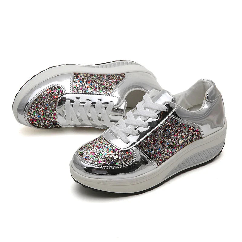 Silver platform sneakers with multicolor glitter panels and white laces on white background
